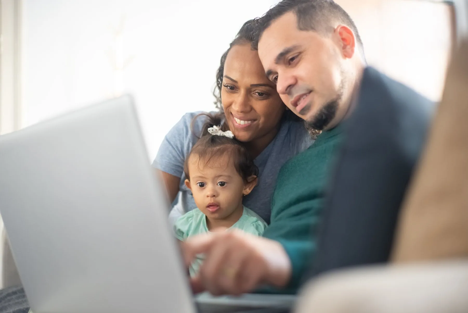 Black family having a video call across different locations