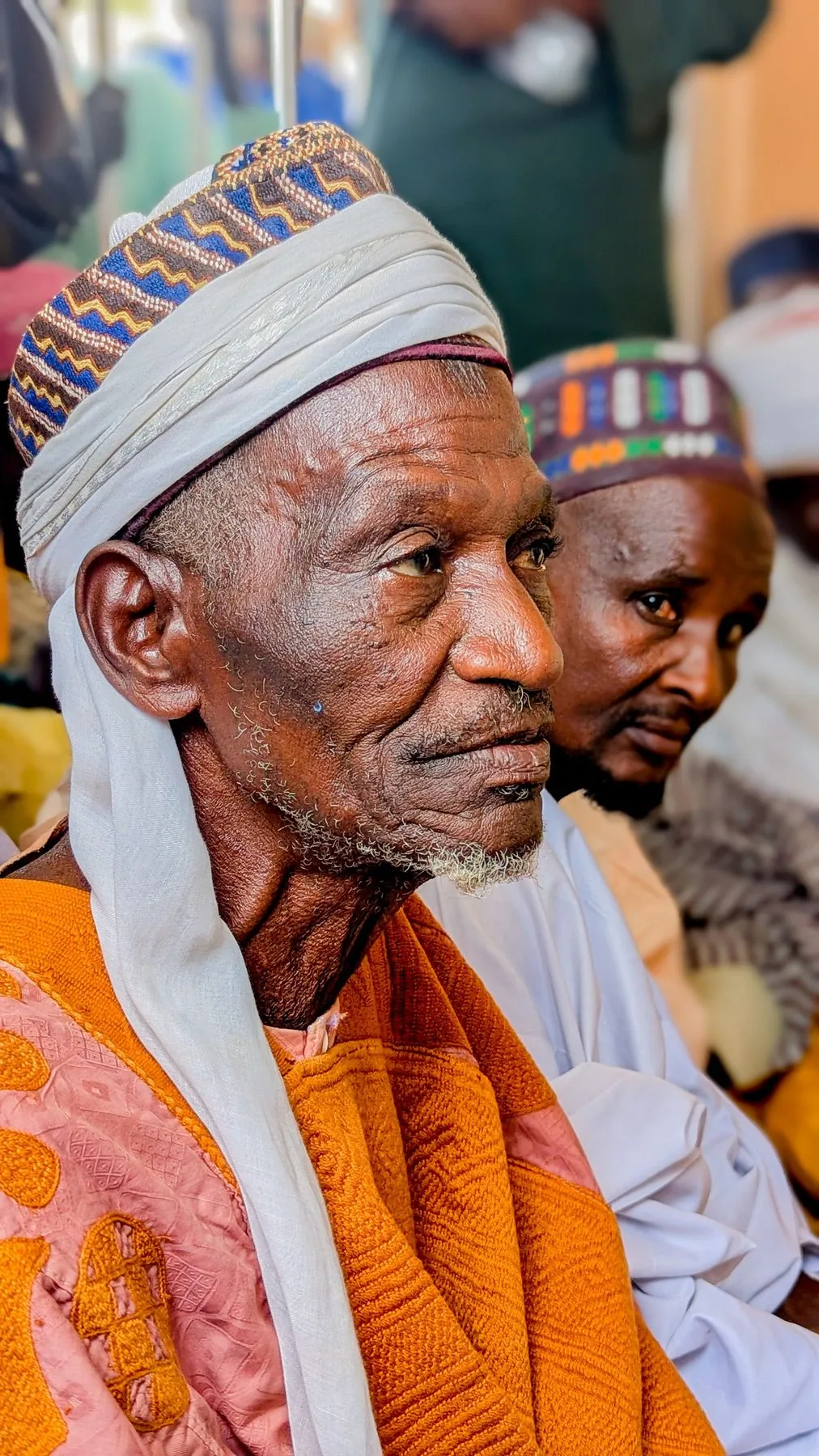 Older man seated outside beside a building